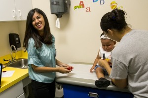 two adults and an infant in a pediatric hospital room