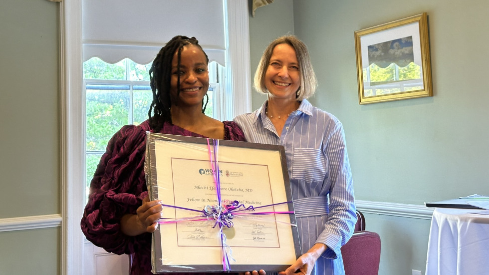 photo of Dr. Lechner presenting diploma to Dr. Okotcha