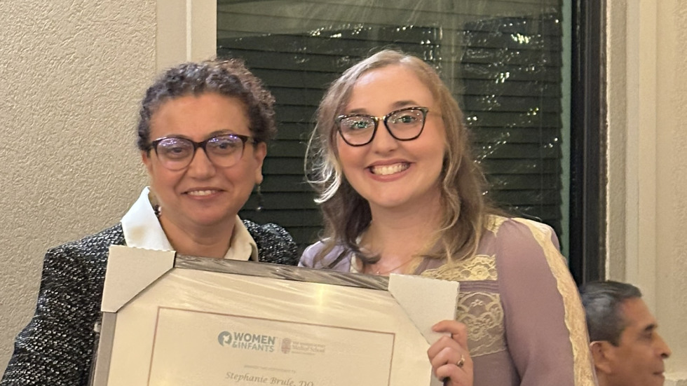 photo of Dr. Gogcu presenting diploma to Dr. Brule 